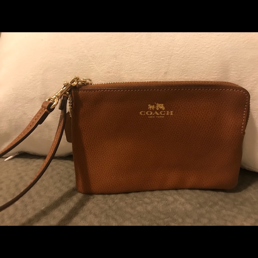 Coach tan leather wristlet.
